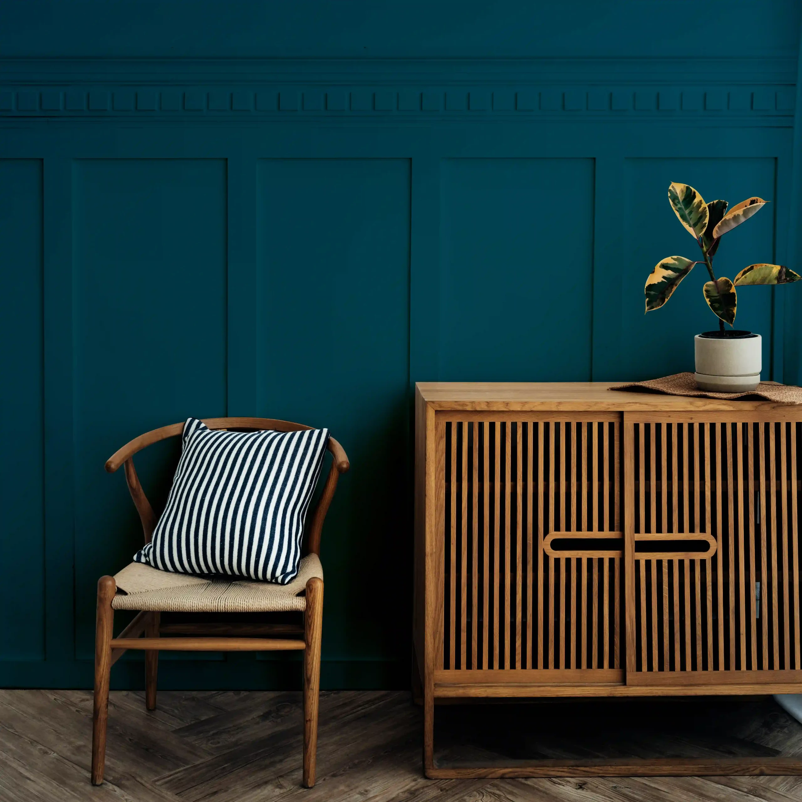 scandinavian-vintage-wood-cabinet-with-chair-by-dark-blue-wall